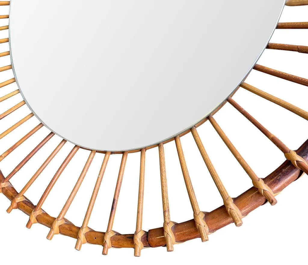 A 1970s Italian oval pencil reed bamboo mirror with original mirror plate fixed with brass circular fittings