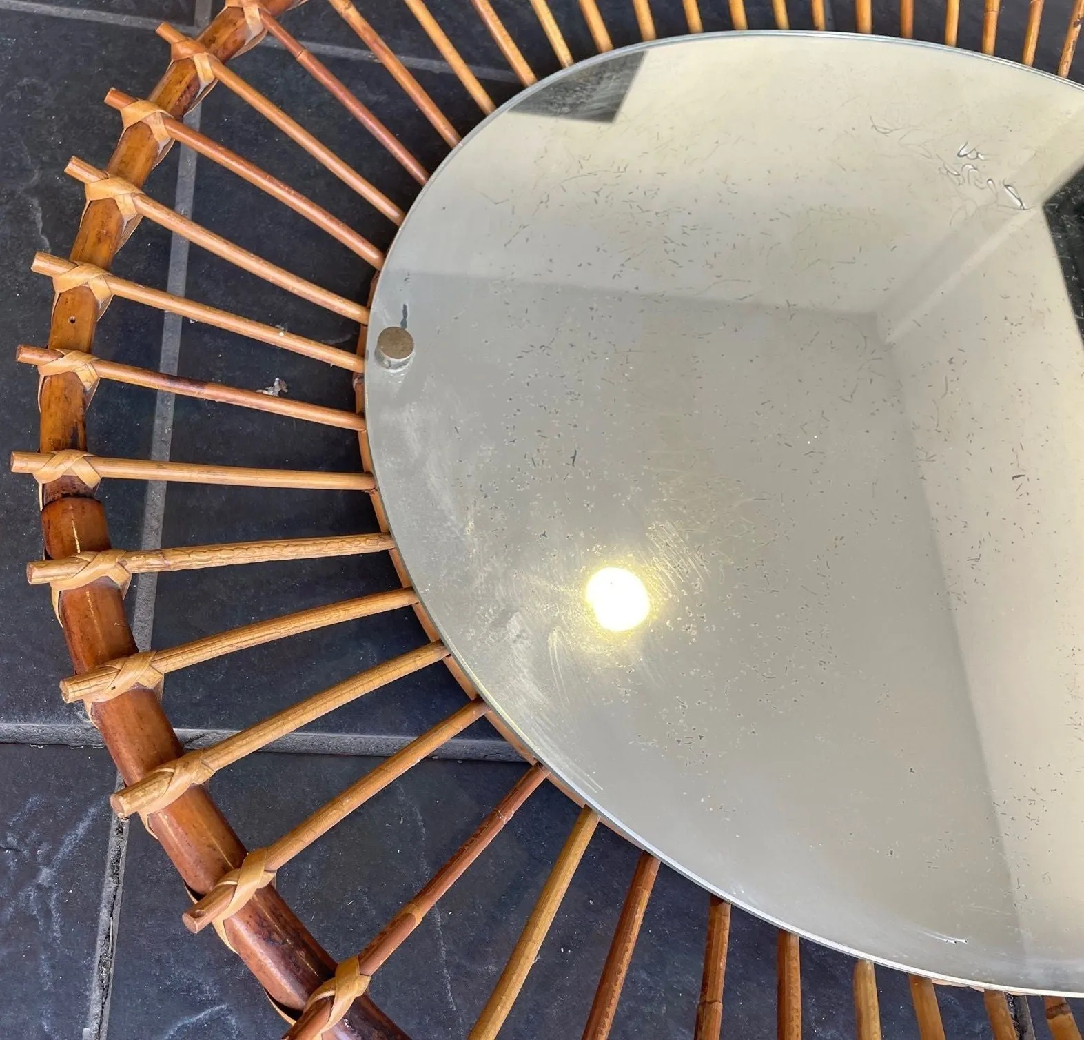 A 1970s Italian oval pencil reed bamboo mirror with original mirror plate fixed with brass circular fittings